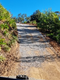 A steep new gravel driveway, graded and compacted